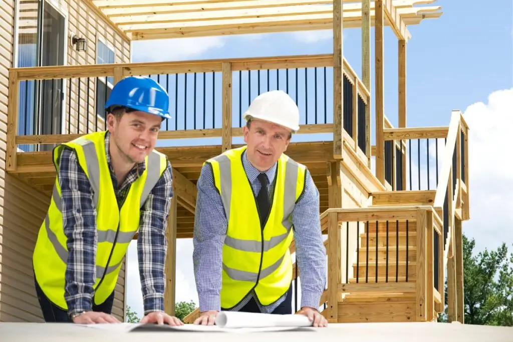 two custom deck building contractors looking on deck building plan