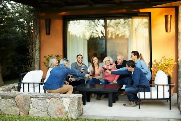 family and friends toasting wine glass in patio