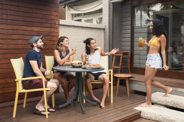 group of young friends sitting on decking