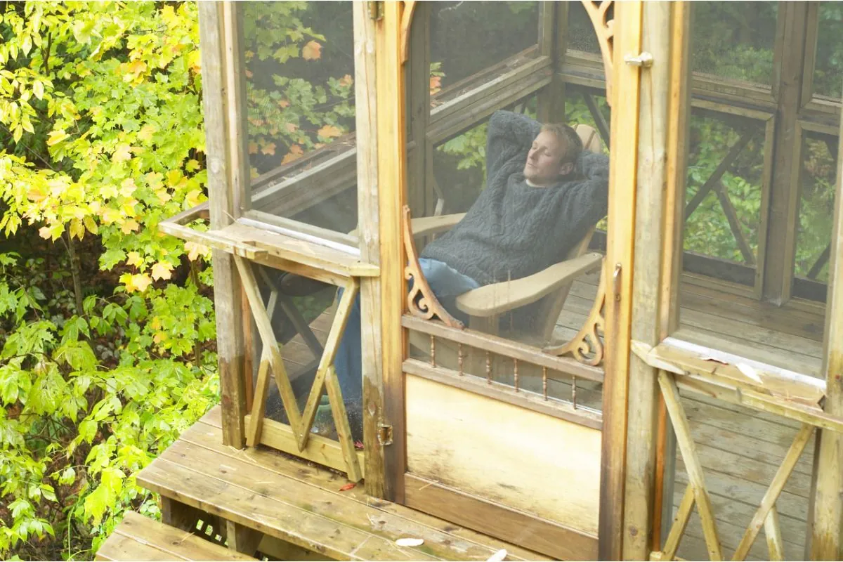 man relaxing in screened porch