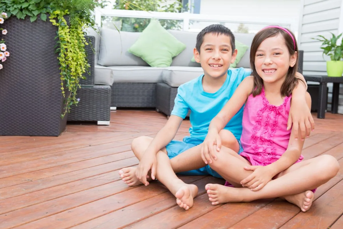 smiling children sitting on deck