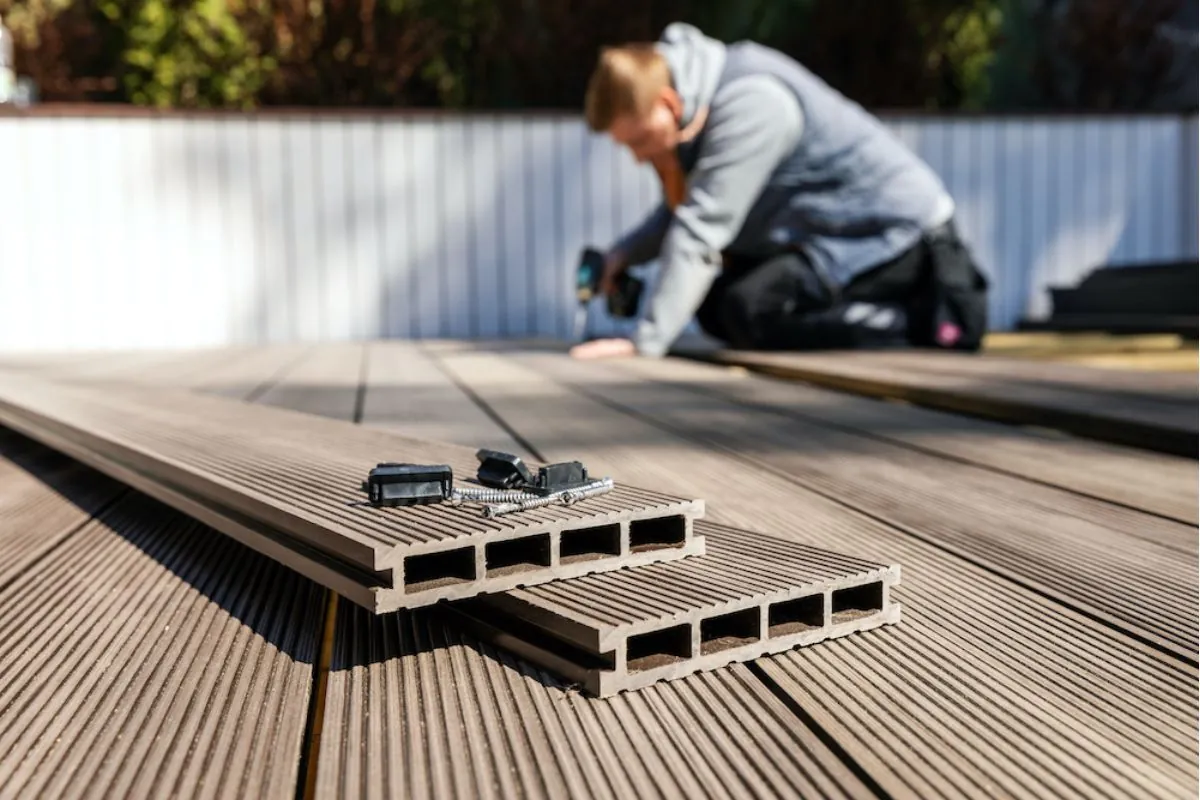 a man installing new deck using composite deck material