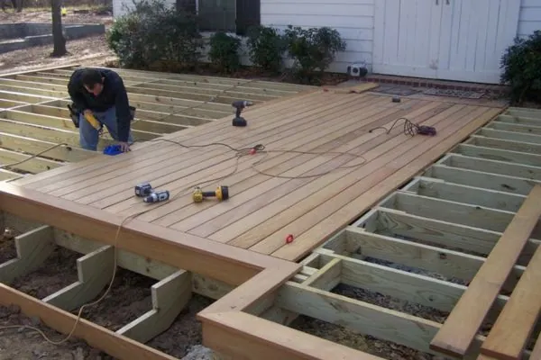 deck builder working on deck board replacement